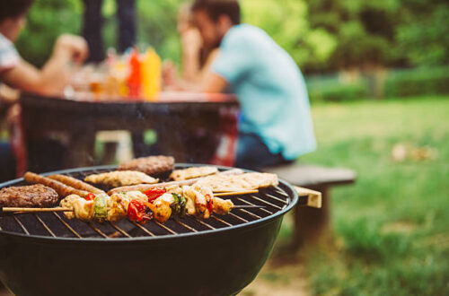 Friends Making Barbecue And Having Lunch In The Nature.