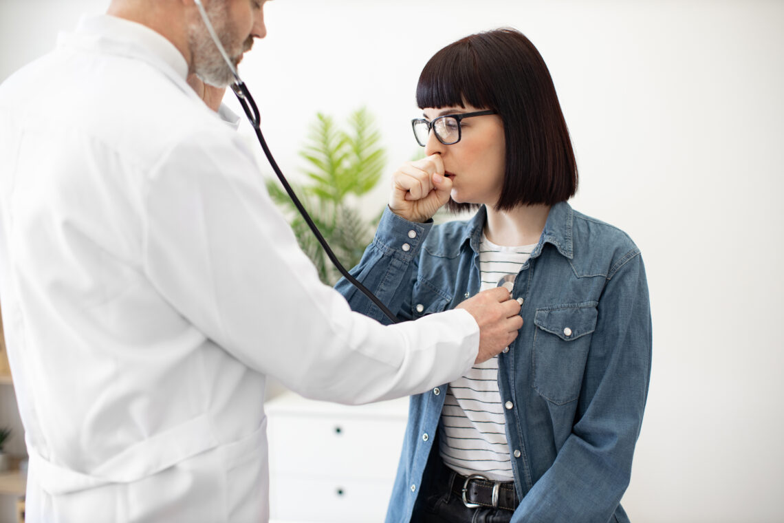 Physician Checking Woman's Lungs During Medical Examination