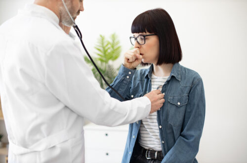 Physician Checking Woman's Lungs During Medical Examination