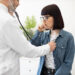 Physician Checking Woman's Lungs During Medical Examination