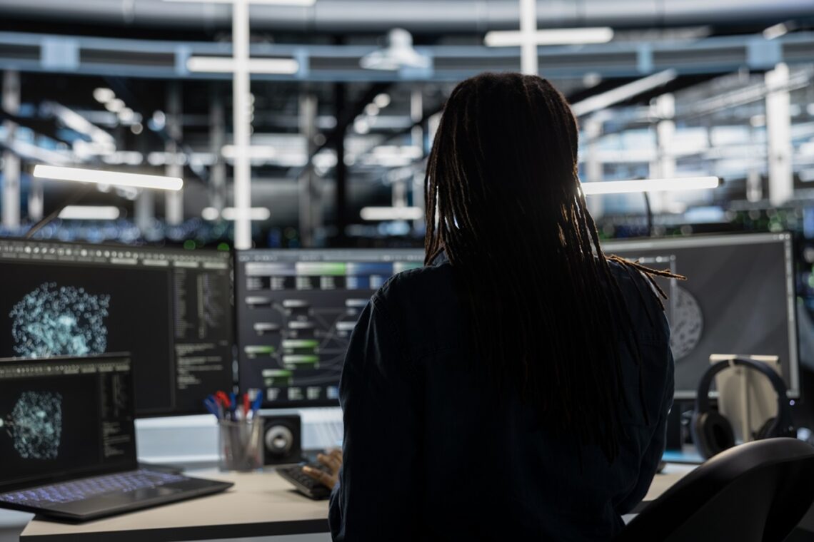 Data center technician uses AI visualization tool on PC to oversee tasks